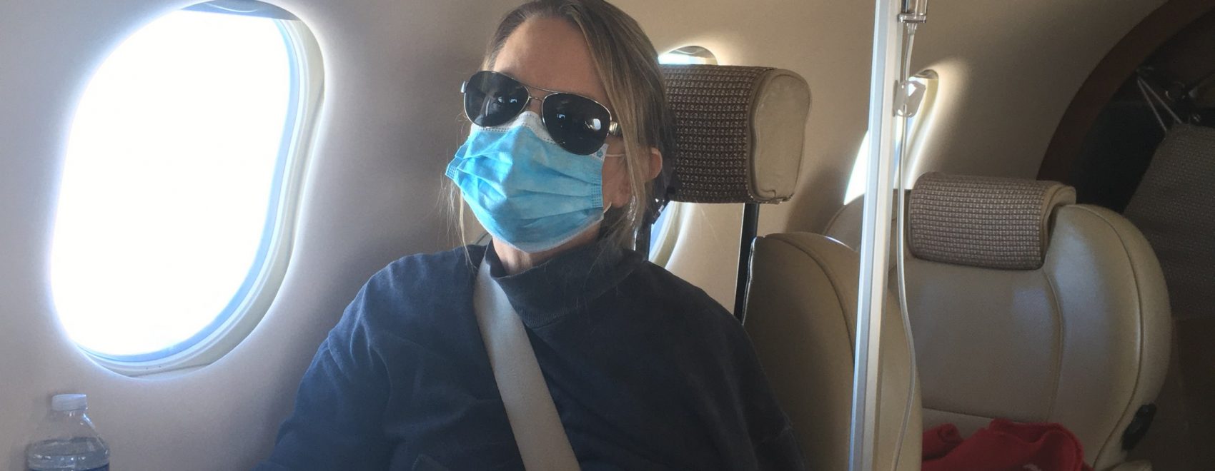 Mom traveling on a free medical flight to cancer treatment